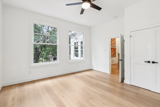 unfurnished room featuring light hardwood / wood-style floors and ceiling fan