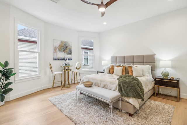 bedroom featuring multiple windows, ceiling fan, and light hardwood / wood-style floors