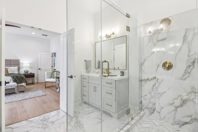 bathroom featuring hardwood / wood-style floors, vanity, and an enclosed shower