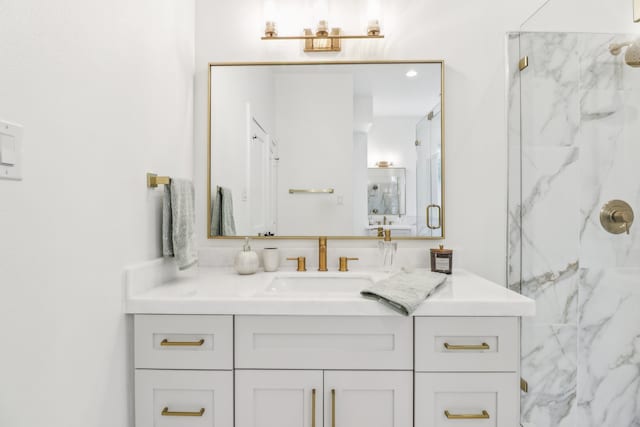 bathroom featuring vanity and an enclosed shower