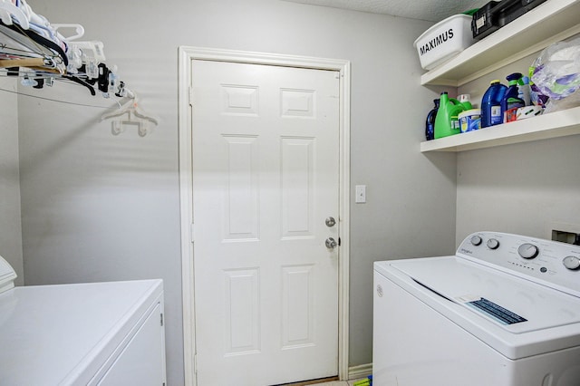 washroom with washer and dryer and a textured ceiling