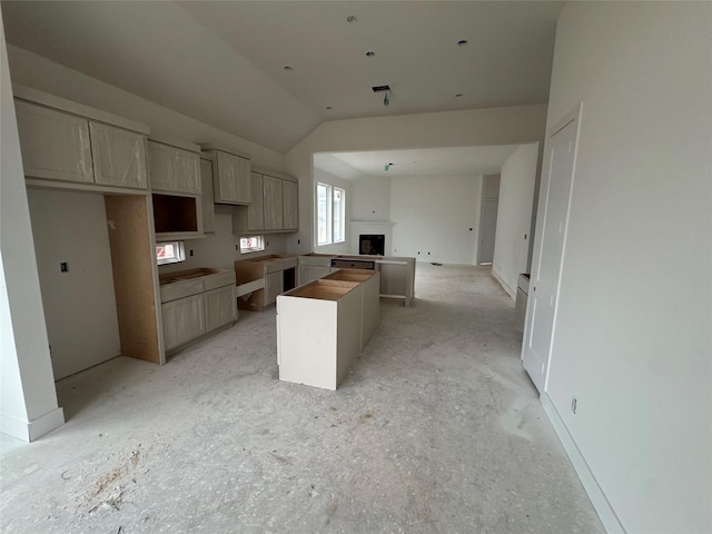 kitchen with lofted ceiling and a kitchen island