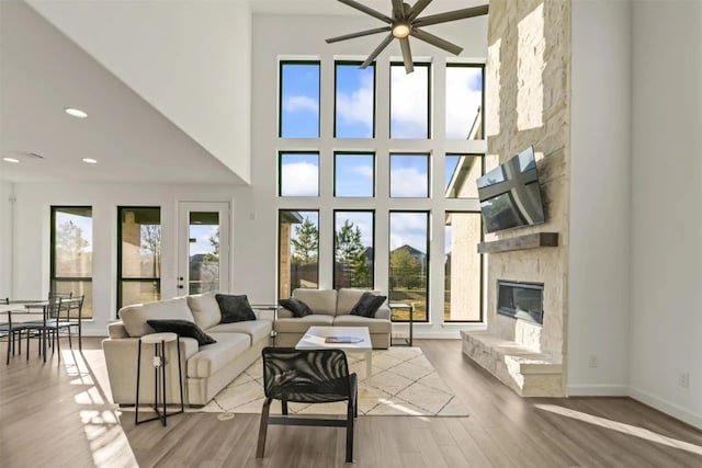 living room featuring a fireplace, hardwood / wood-style floors, and a healthy amount of sunlight