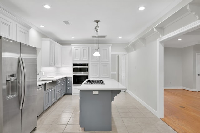 kitchen featuring white cabinetry, hanging light fixtures, light tile patterned flooring, a kitchen island, and appliances with stainless steel finishes