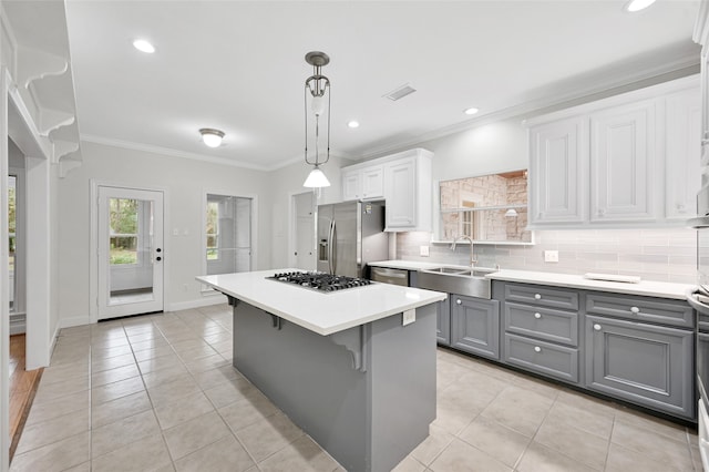 kitchen with white cabinetry, sink, gray cabinets, a kitchen island, and appliances with stainless steel finishes