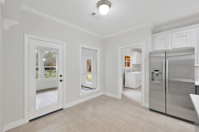 entryway with light tile patterned floors, washer / clothes dryer, and ornamental molding