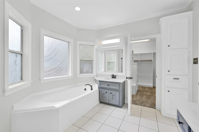 bathroom featuring tile patterned floors, vanity, a healthy amount of sunlight, and ornamental molding