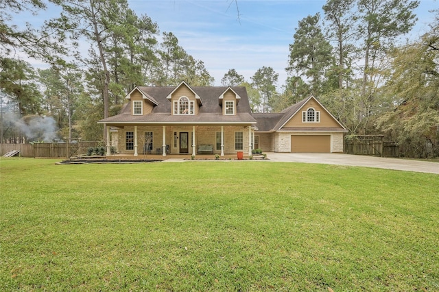 new england style home featuring covered porch, a front yard, and a garage