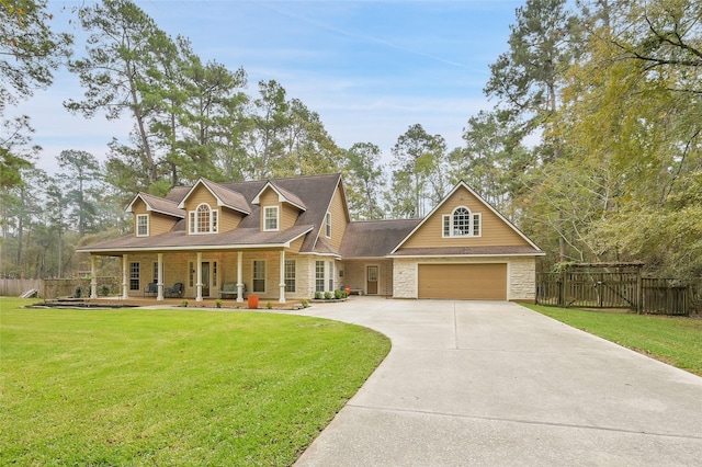 view of front facade featuring a porch, a front yard, stone siding, and fence