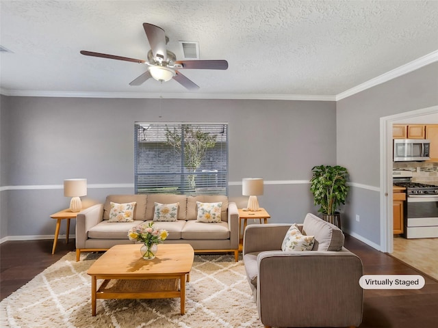 living room with hardwood / wood-style floors, a textured ceiling, ceiling fan, and crown molding