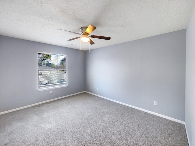 unfurnished room with carpet, ceiling fan, and a textured ceiling