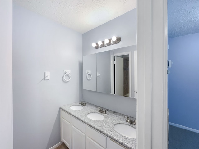 bathroom featuring vanity and a textured ceiling