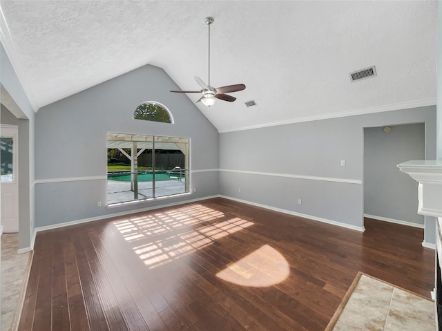 unfurnished living room with a textured ceiling, dark hardwood / wood-style flooring, vaulted ceiling, and ceiling fan