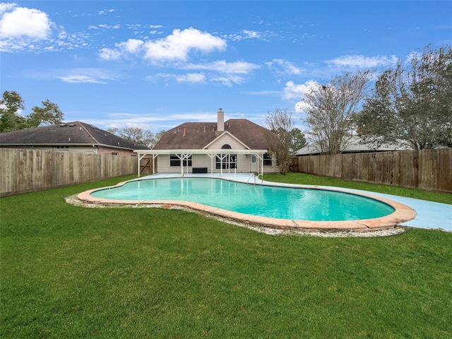 view of swimming pool featuring a lawn and a patio area