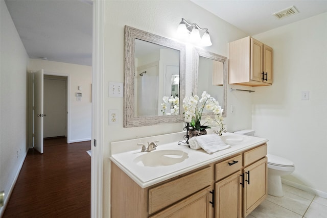 bathroom with hardwood / wood-style floors, vanity, and toilet