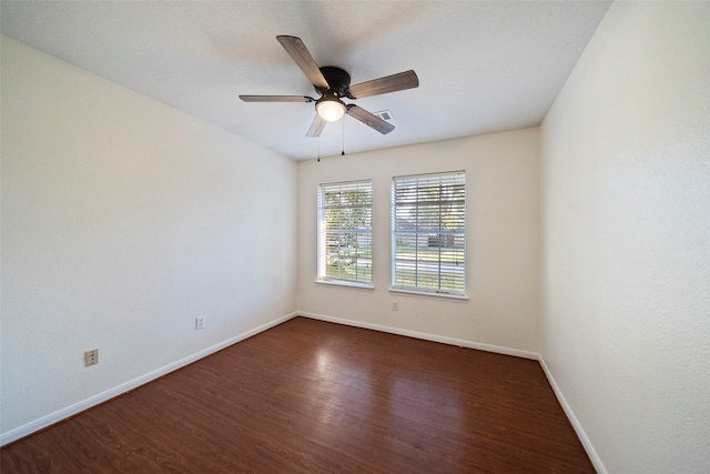 unfurnished room with ceiling fan and dark hardwood / wood-style flooring