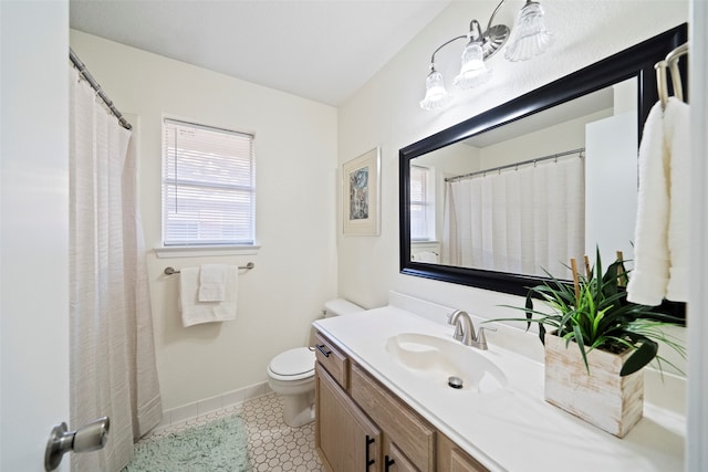 bathroom featuring tile patterned flooring, vanity, and toilet