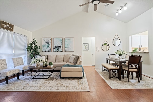 living room featuring ceiling fan, a healthy amount of sunlight, and hardwood / wood-style flooring