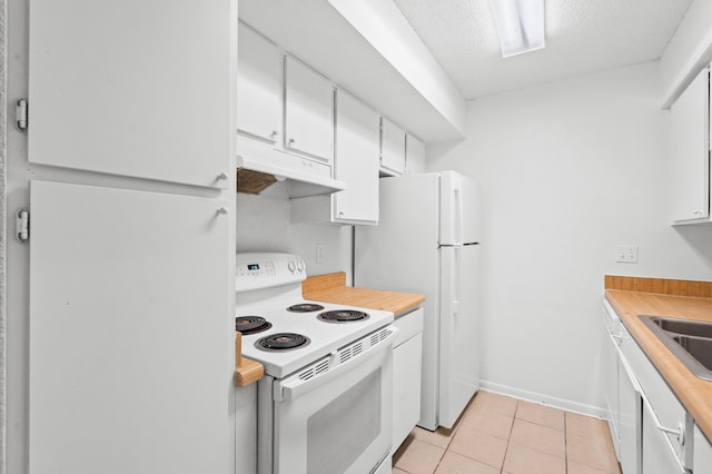 kitchen with white cabinetry, white appliances, a textured ceiling, and light tile patterned floors