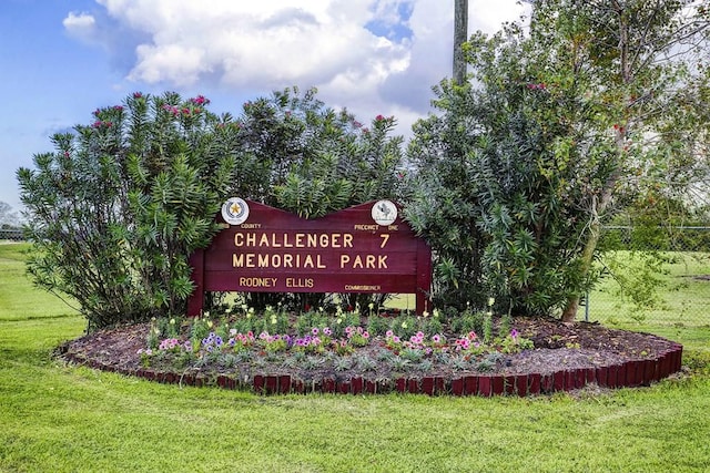 community / neighborhood sign with a yard