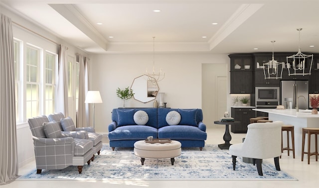 living room featuring a tray ceiling, ornamental molding, and a notable chandelier