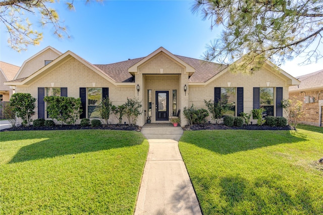 ranch-style home featuring a front lawn