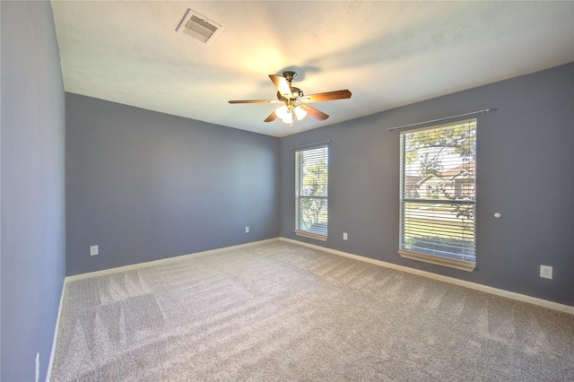 empty room with ceiling fan and carpet