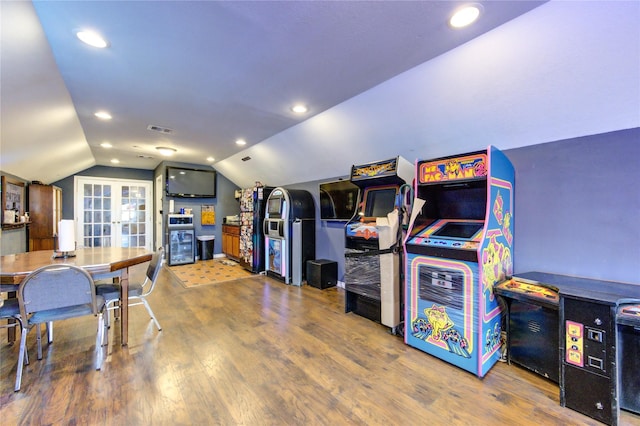 playroom with wood-type flooring and vaulted ceiling