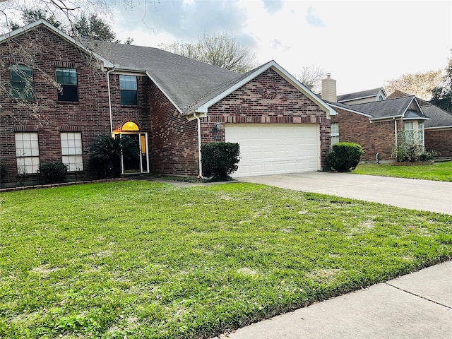 view of front of home with a garage and a front lawn