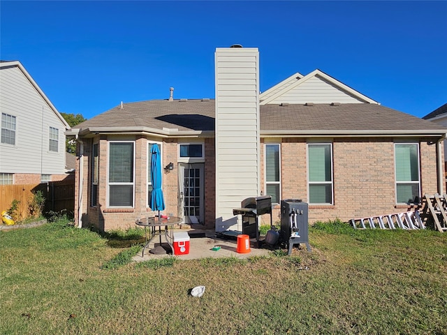 rear view of property featuring a yard and a patio