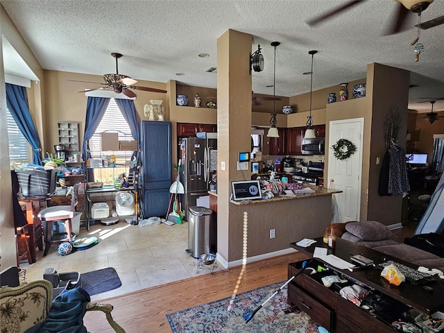 living room featuring light hardwood / wood-style floors and a textured ceiling