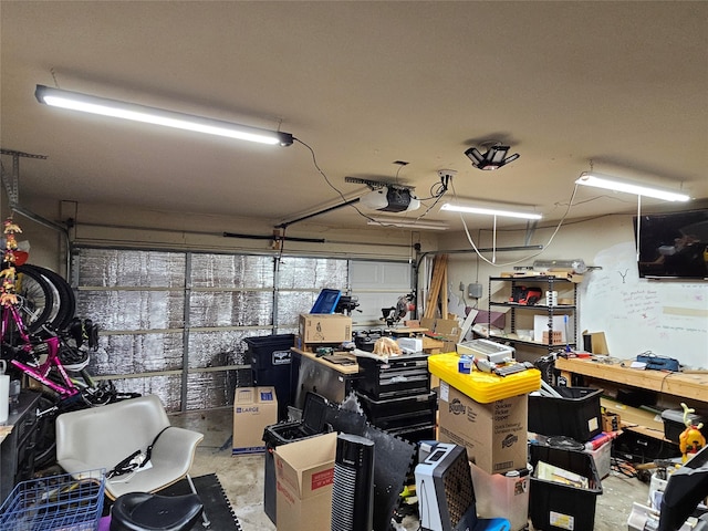 garage with a workshop area and a garage door opener