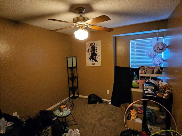 carpeted bedroom with a textured ceiling and ceiling fan