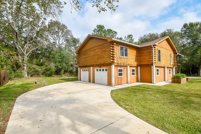 view of property exterior featuring a yard and a garage