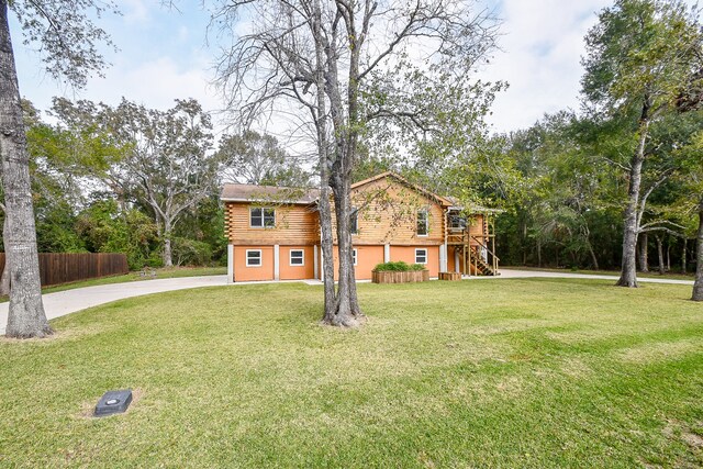 log home featuring a front yard and a garage