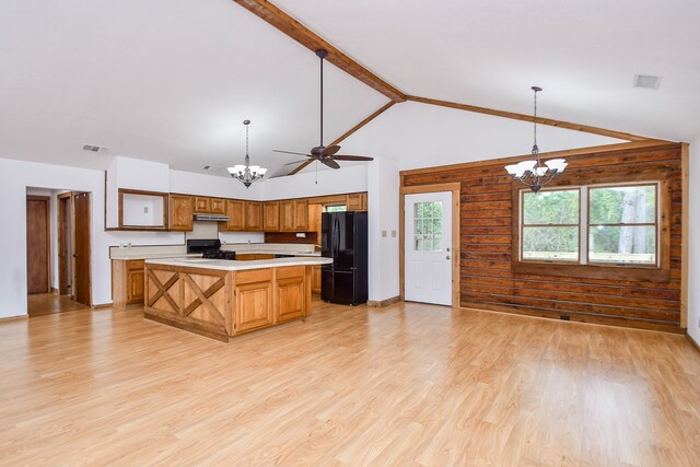 kitchen with pendant lighting, light hardwood / wood-style floors, a kitchen island, black appliances, and ceiling fan with notable chandelier