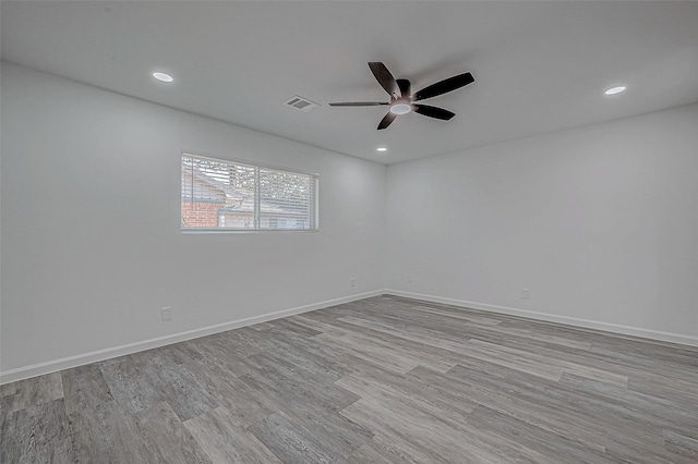 empty room with ceiling fan and light wood-type flooring