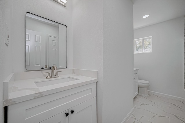 bathroom with vanity and toilet