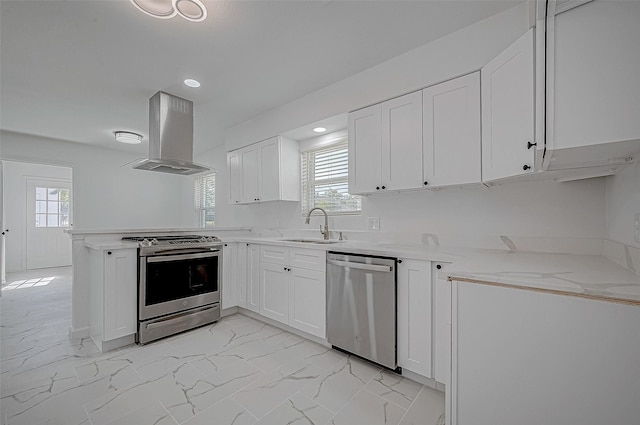 kitchen with appliances with stainless steel finishes, sink, white cabinetry, and range hood