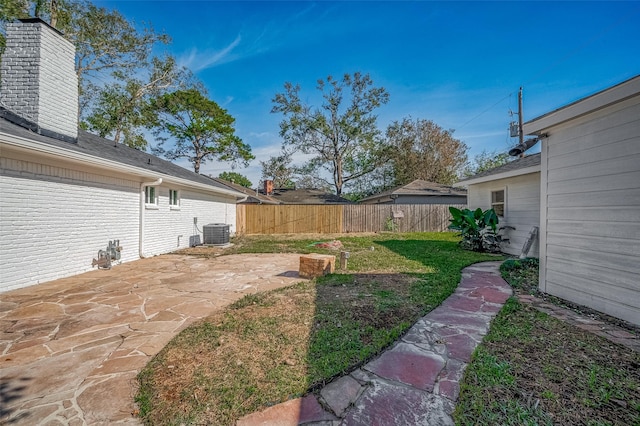 view of yard featuring a patio and central AC unit