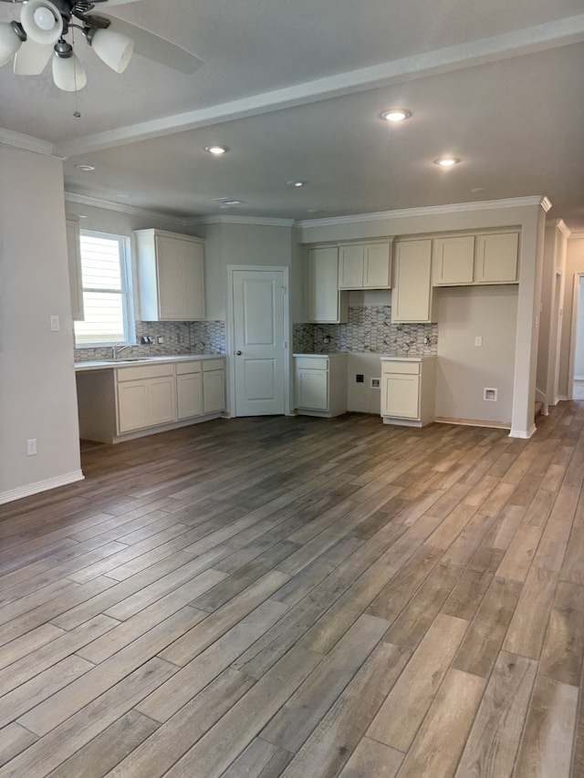 kitchen featuring light wood-type flooring and crown molding