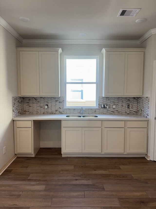 kitchen with white cabinets, backsplash, sink, and dark wood-type flooring