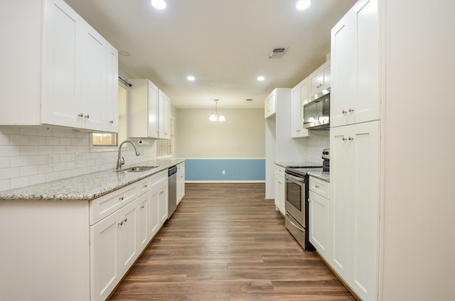 kitchen with white cabinets, appliances with stainless steel finishes, and dark wood-type flooring