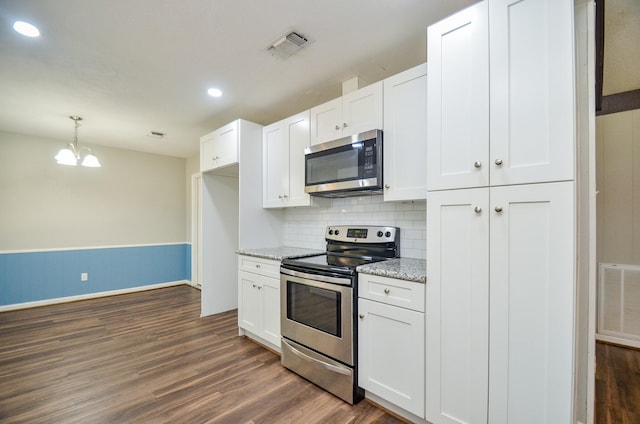 kitchen featuring light stone countertops, white cabinets, dark wood-type flooring, and appliances with stainless steel finishes