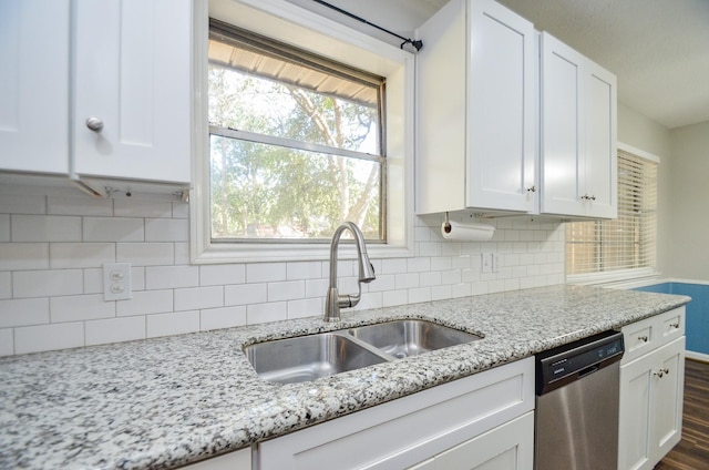 kitchen featuring dishwasher, white cabinetry, a healthy amount of sunlight, and sink