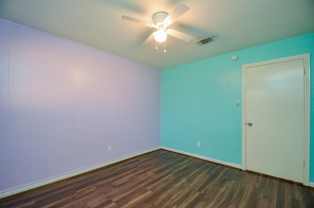 unfurnished room featuring dark hardwood / wood-style flooring and ceiling fan