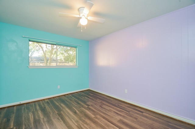 empty room featuring ceiling fan and dark hardwood / wood-style flooring