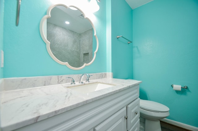 bathroom featuring hardwood / wood-style flooring, vanity, and toilet