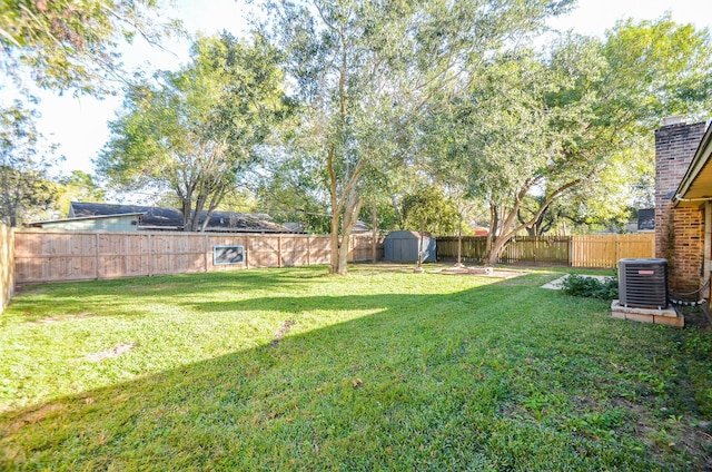 view of yard featuring a shed and cooling unit