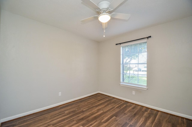 empty room with dark hardwood / wood-style flooring and ceiling fan